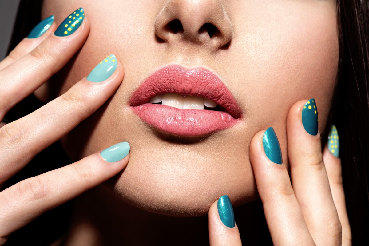 woman-s-fingers-with-motton-blue-color-nails-face (1)
